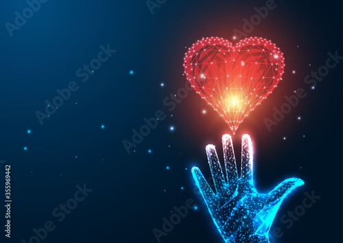 Futuristic love concept with glowing low polygonal female hand reaching red heart