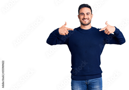 Young handsome man wearing casual clothes looking confident with smile on face, pointing oneself with fingers proud and happy.