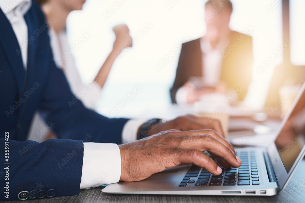 Businessman works in office with a laptop. Concept of internet sharing and company startup Businessman works in office with a laptop. Concept of internet sharing and company startup