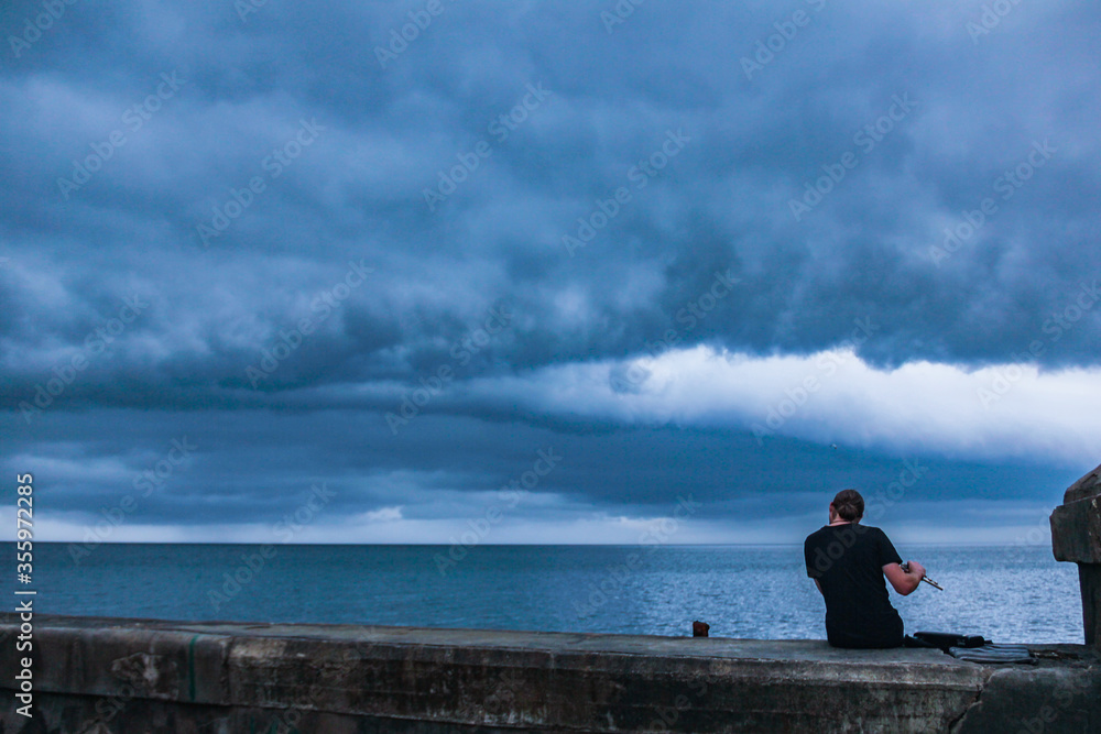 Flute player in stormy weather. 