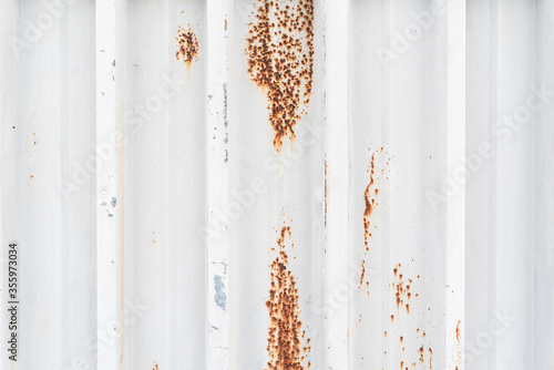 Red spots of rust on the white metal texture construction copy space for text title abstract © Valentin