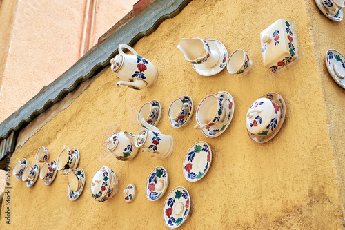 Old tea set on the wall, Turkey Antalya, old city. Antique cups, saucers and teapot on the wall