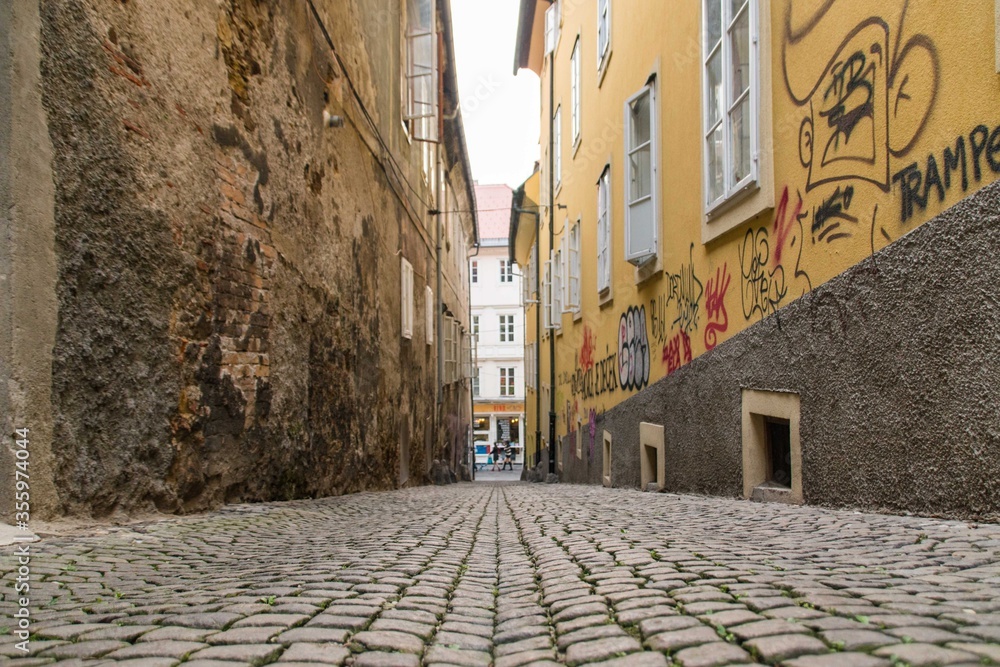 An old street with cobblestones and graffiti in Ljubljana, Slovenia
