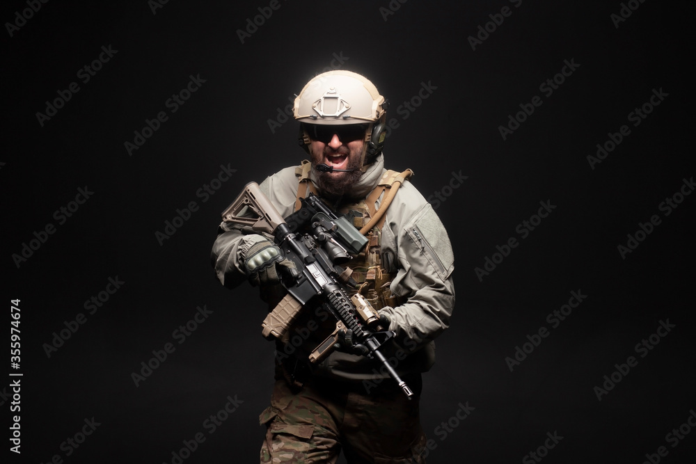 American commando in military equipment and arms running at night, ranger screaming in the dark, elite troops, war concept American commando in military equipment and arms running at night, ranger screaming in the dark, elite troops, war concept
