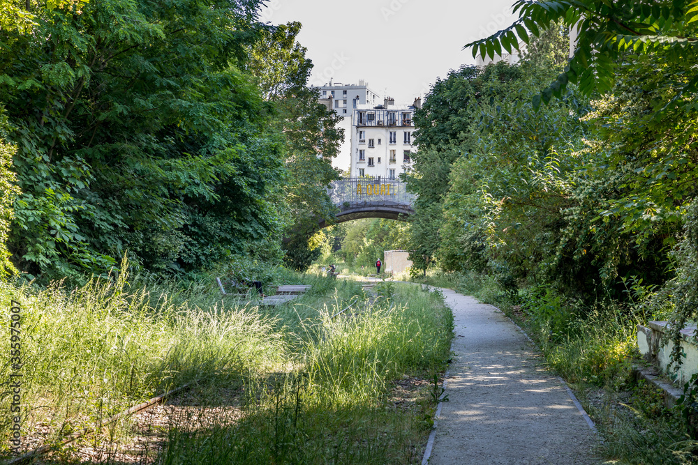 Paris, France - June 2, 2020: View of the old railways of the Petite Ceinture in Paris, arranged as a promenade zone Paris, France - June 2, 2020: View of the old railways of the Petite Ceinture in Paris, arranged as a promenade zone