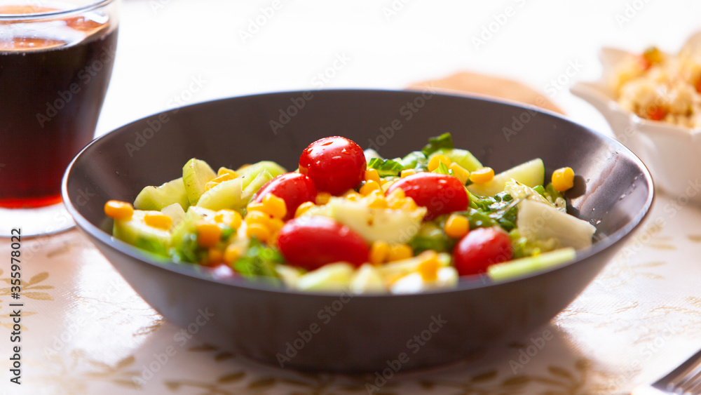 Healthy green salad. bowl of salad with vegetables and greens on table