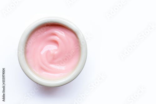 Sour cream or yogurt on white bowl on white