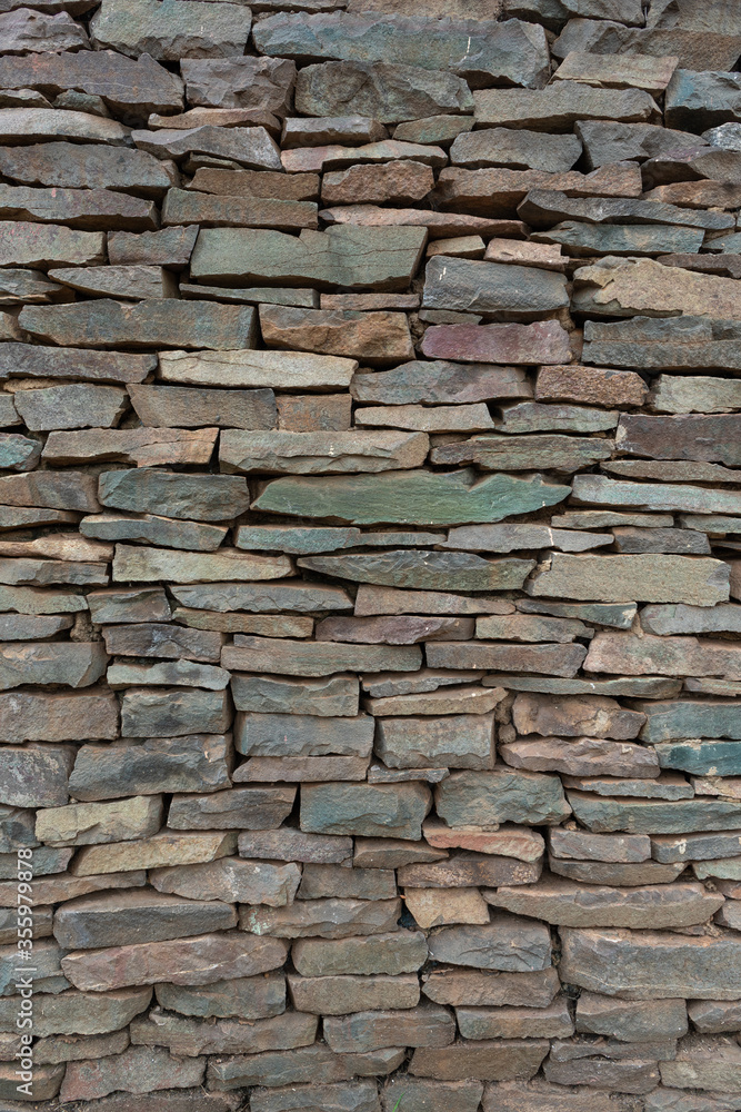 Decorative stone wall in various shades and sober colors, for background use.