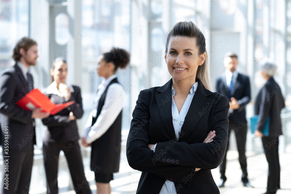 Portrait of a business woman with colleagues on background Portrait of a business woman with colleagues on background