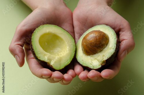 avocado in a hand of woman Isolated on colored