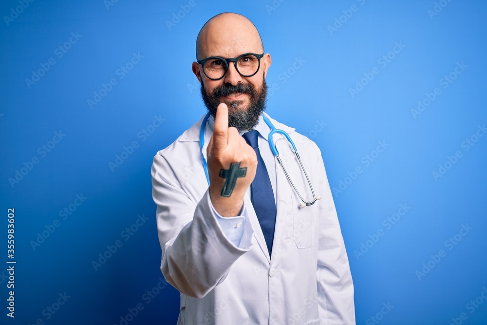Handsome bald doctor man with beard wearing glasses and stethoscope over blue background Beckoning come here gesture with hand inviting welcoming happy and smiling Handsome bald doctor man with beard wearing glasses and stethoscope over blue background Beckoning come here gesture with hand inviting welcoming happy and smiling