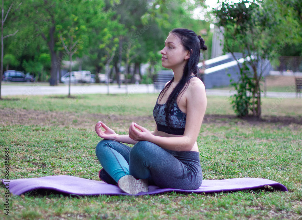 Beautiful girl is doing yoga Easy Pose Sukhasana. Concept of sport Beautiful girl is doing yoga Easy Pose Sukhasana. Concept of sport