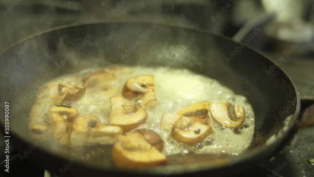 chef cooking sauteed mushrooms in pan slow motion chef cooking sauteed mushrooms in pan slow motion