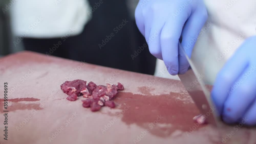 chef chopping meat on a cutting board slow motion chef chopping meat on a cutting board slow motion