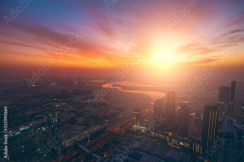 Dubai skyline at sunrise, modern futuristic luxury Arab city, aerial view.