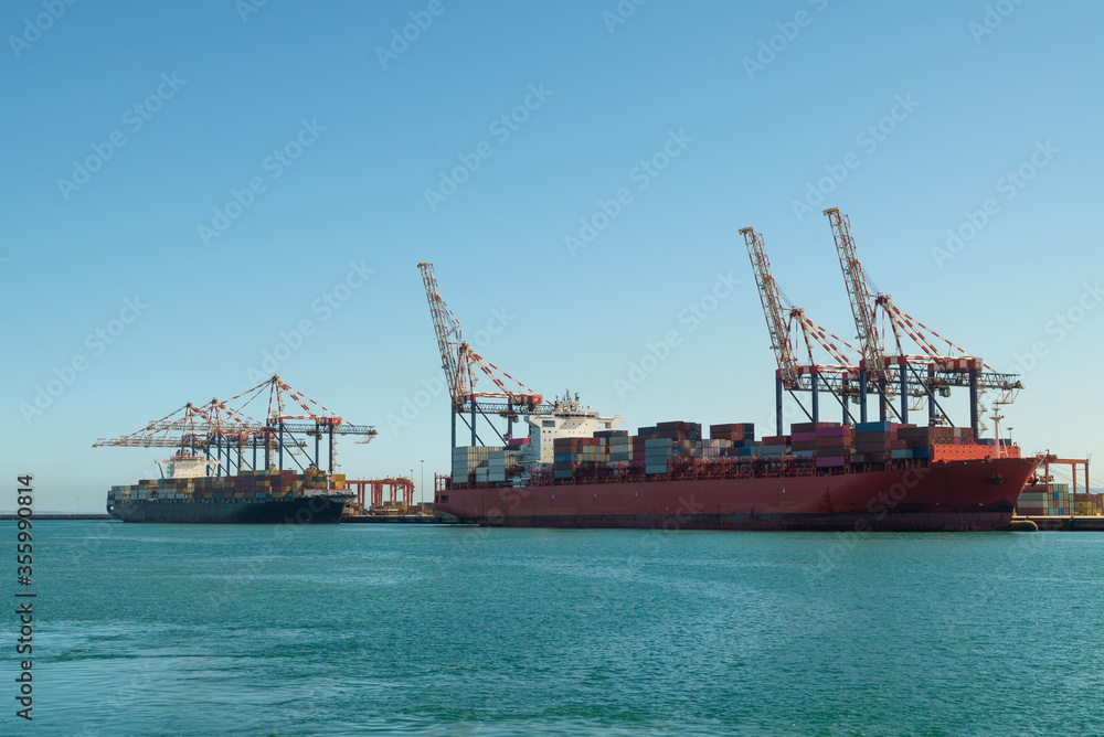 Cranes in the port of Cape Town unload container ships.