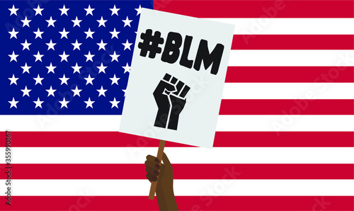 Black lives matter hand holding protest placard on an American flag