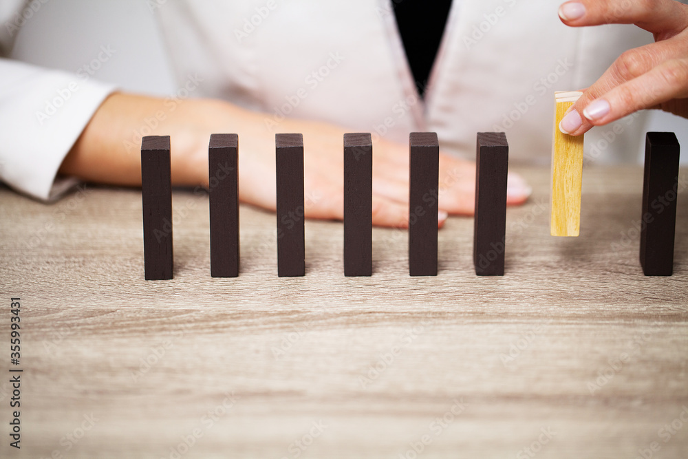 Business concept, woman's hands make up wooden cubes symbolizing the success of the company