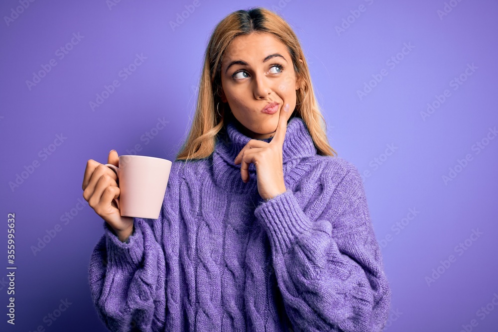 Young beautiful blonde woman drinking cup of coffee over isolated purple background serious face thinking about question, very confused idea Young beautiful blonde woman drinking cup of coffee over isolated purple background serious face thinking about question, very confused idea