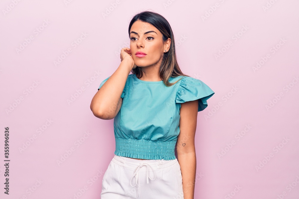 Young beautiful brunette woman standing over isolated pink background Young beautiful brunette woman standing over isolated pink background