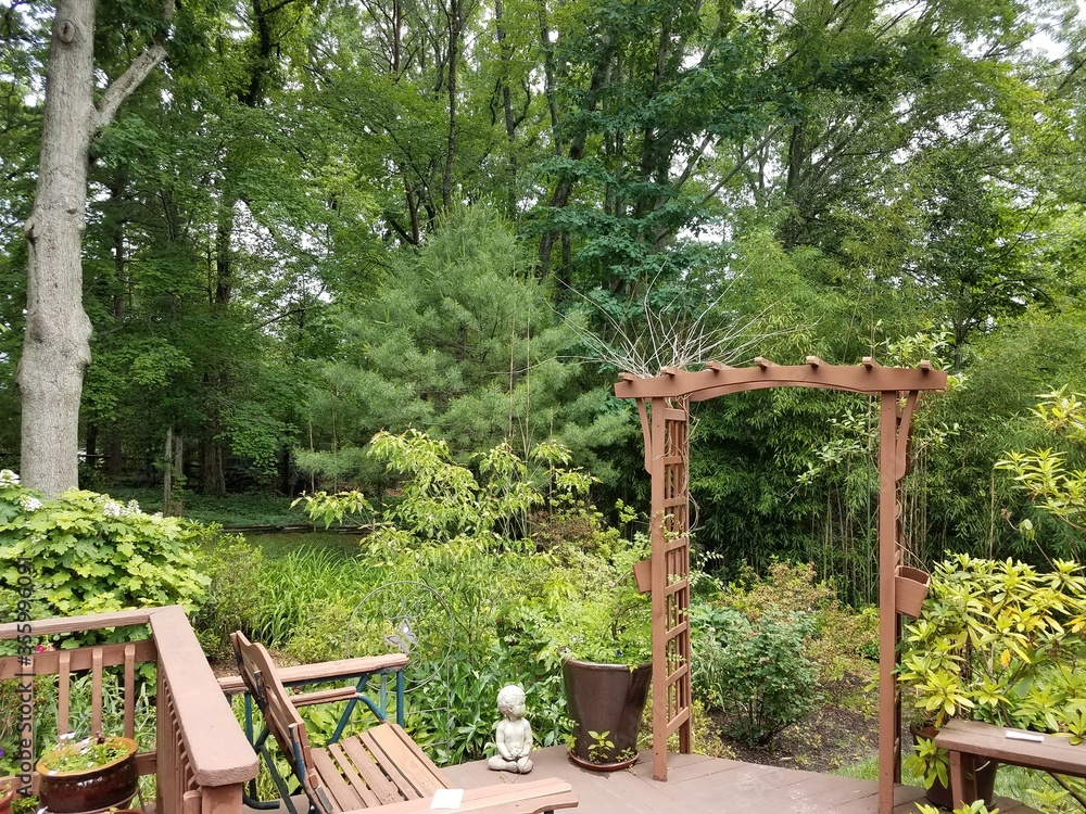 wood deck with bench and lattice and trees