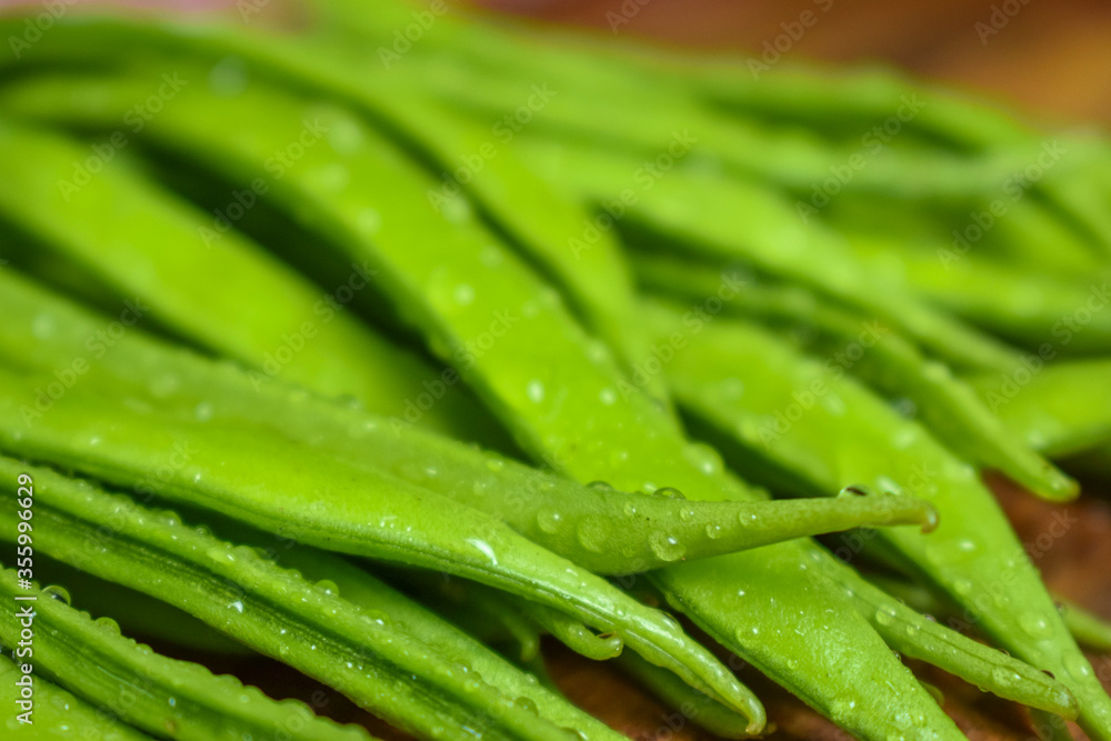 Cluster Bean or GuarAlso Known as Gavar, Guwar or Guvar Bean isolated on Wooden Background Cluster Bean or GuarAlso Known as Gavar, Guwar or Guvar Bean isolated on Wooden Background
