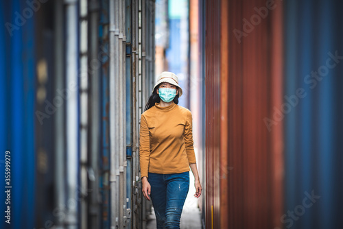 Portrait of an Asian woman wearing a surgical mask to prevent the infection from the coronavirus COVID-19 virus.
