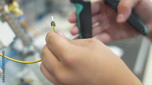 man crimping socket on a ground wire with crimper pliers slow motion