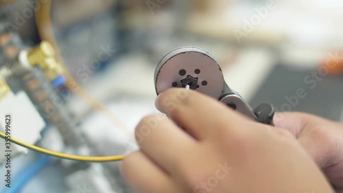 man crimping socket on a ground wire with crimper pliers slow motion photo