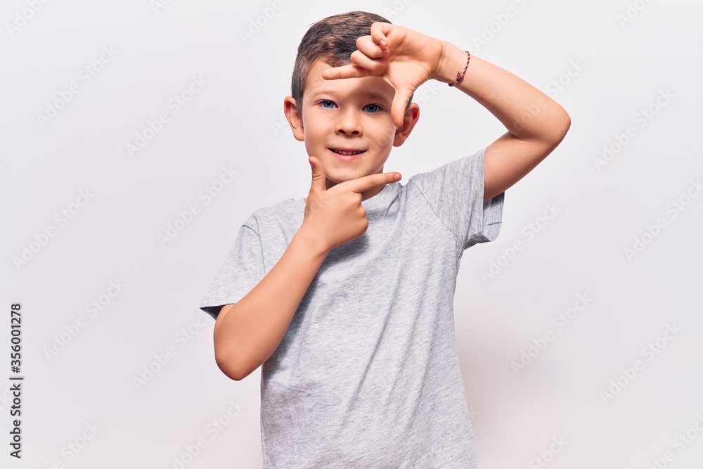 Cute blond kid wearing casual clothes smiling making frame with hands and fingers with happy face. creativity and photography concept. Cute blond kid wearing casual clothes smiling making frame with hands and fingers with happy face. creativity and photography concept.