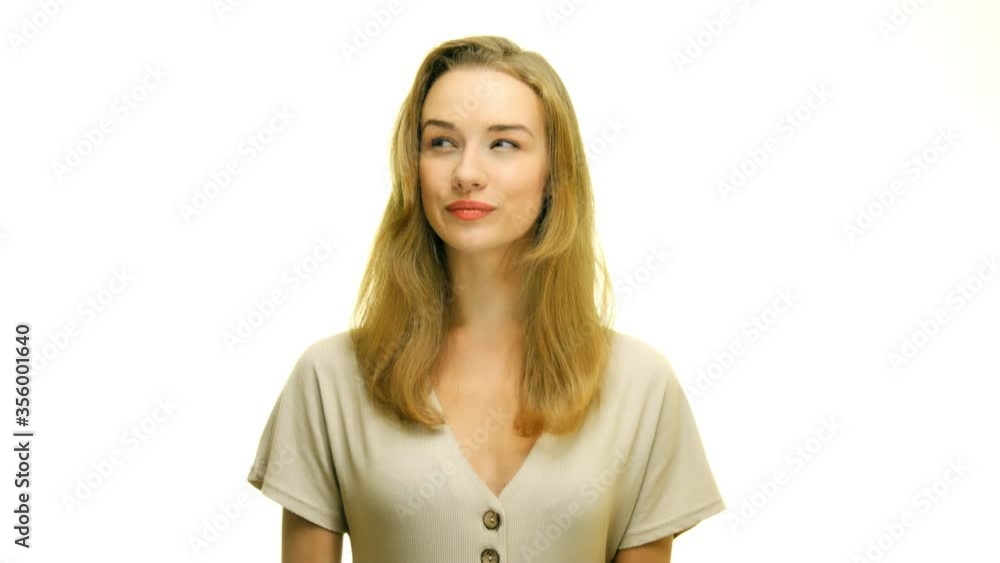 young natural woman in studio on uniform background looks around at copy space young natural woman in studio on uniform background looks around at copy space