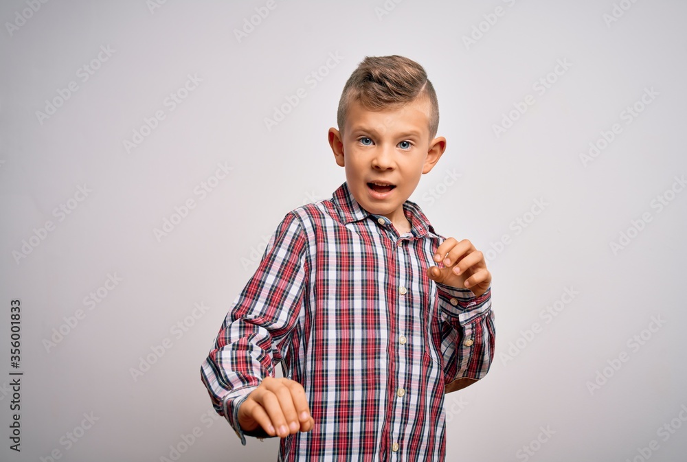 Young little caucasian kid with blue eyes wearing elegant shirt standing over isolated background disgusted expression, displeased and fearful doing disgust face because aversion reaction. - obrazy, fototapety, plakaty 