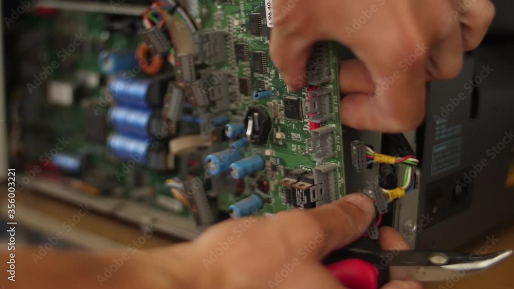 Technician disconnecting motherboard from a machine slow motion Technician disconnecting motherboard from a machine slow motion
