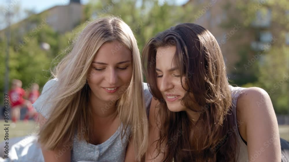 Two teenage girls watching funny videos on TikTok. Two teenage girls watching funny videos on TikTok.