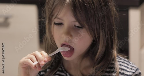 Cute little girl eating ice cream
