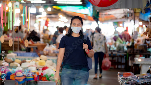 Portrait of Asia woman wearing mask shopping in the fresh market