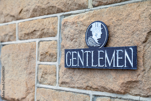 Gentlemen sign on an old stone block wall.