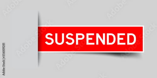 Inserted red color sticker label with word suspended on gray background