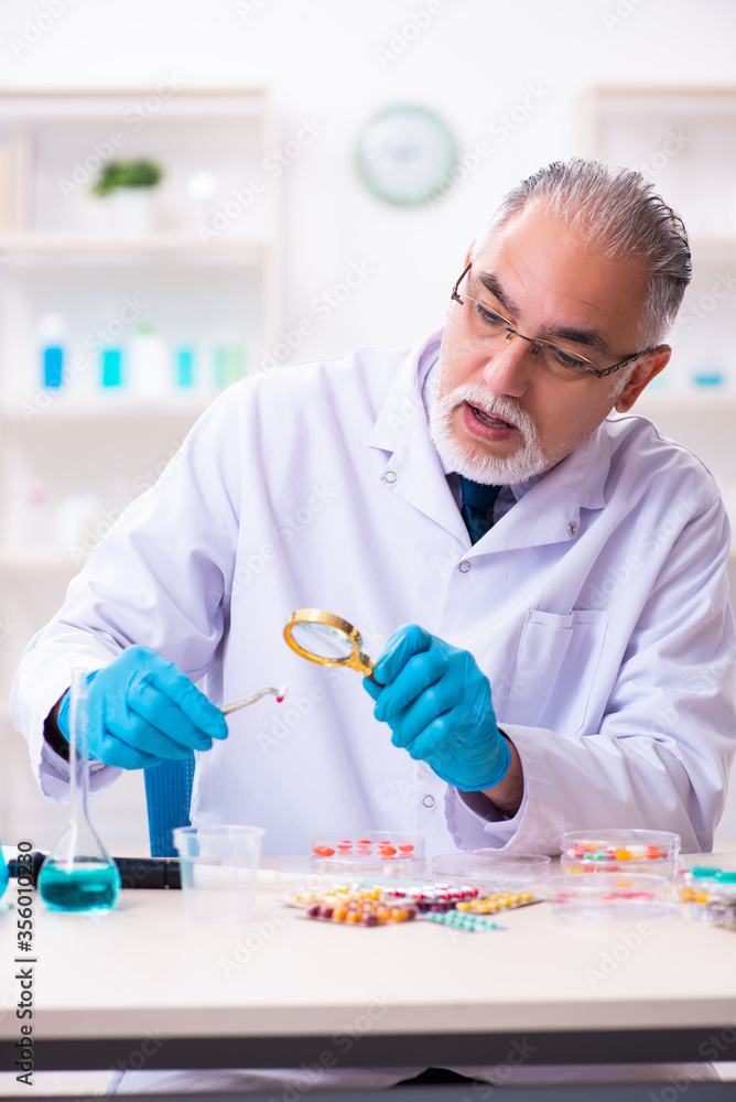 Old male chemist working in the lab Old male chemist working in the lab