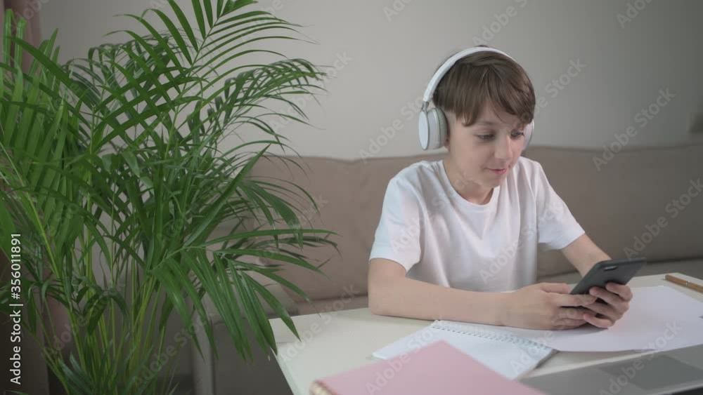 The boy is resting from school and playing a laptop. The boy is resting from school and playing a laptop.