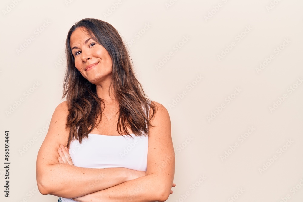Young beautiful brunette woman wearing casual t-shirt standing over isolated white background scared and amazed with open mouth for surprise, disbelief face