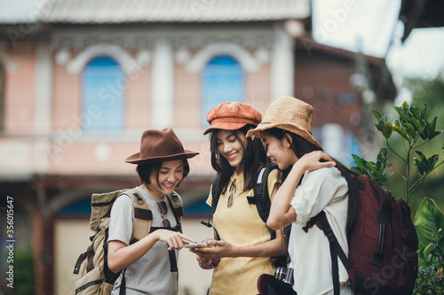 Asian woman group backpacker wearing hat, Young female discussion use map in mobile phone for travel, Friendship traveller backpack travel for new experience. Happy young girl group tourist.