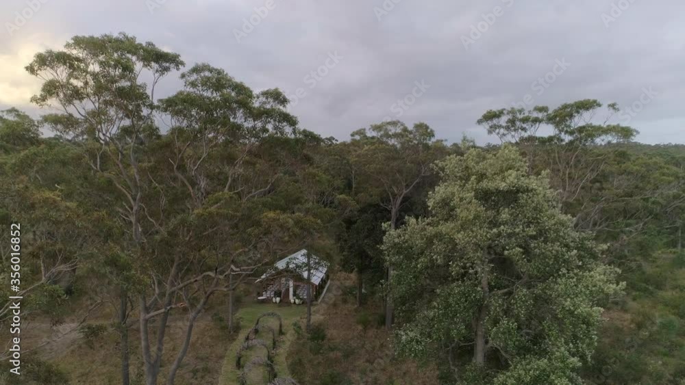 Event venue in the forest with white chars and arched pathway, drone push in Event venue in the forest with white chars and arched pathway, drone push in