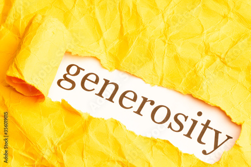the word generosity is seen from under torn orange paper with ragged edges photo