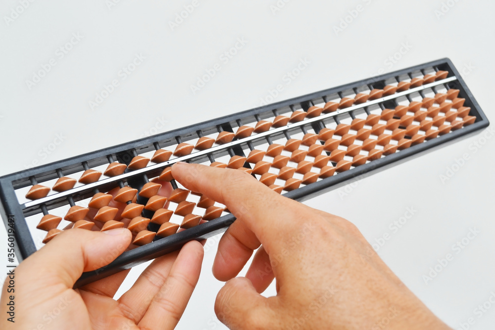 Hands with an abacus on a white background. Hands with an abacus on a white background.