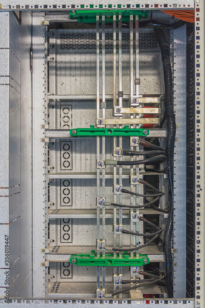 Copper bar in AC distribution panel and connected with cable to circuit breaker. Selective focus. Copper bar in AC distribution panel and connected with cable to circuit breaker. Selective focus.