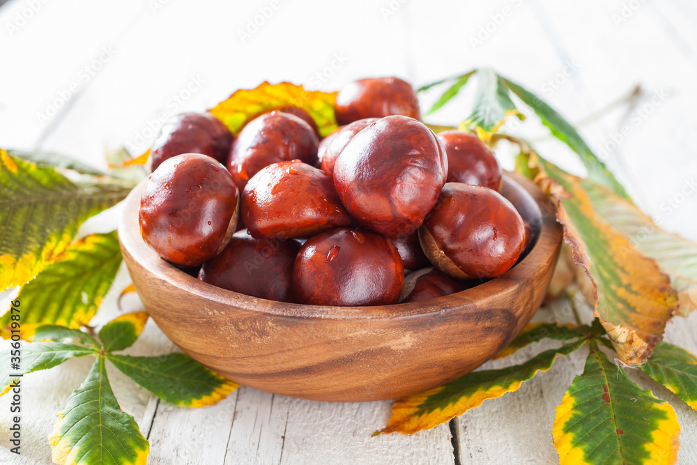 chestnuts in a bowl on a table, selective focus chestnuts in a bowl on a table, selective focus