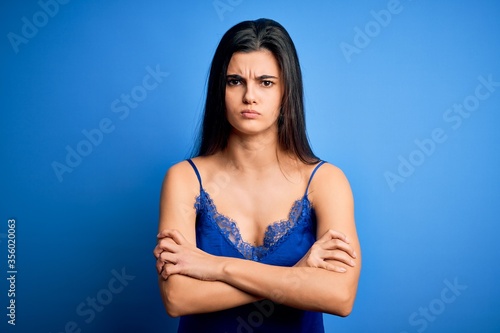Young beautiful brunette woman wearing elegant and comfortable blue lingerie underwear skeptic and nervous, disapproving expression on face with crossed arms. Negative person.