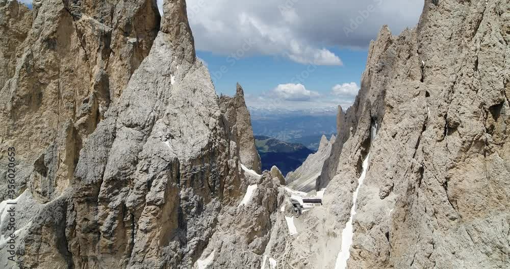 Narrow canyon on Sassolungo. Aerial view of Langkofelscharte and Val gardena in the Background Narrow canyon on Sassolungo. Aerial view of Langkofelscharte and Val gardena in the Background