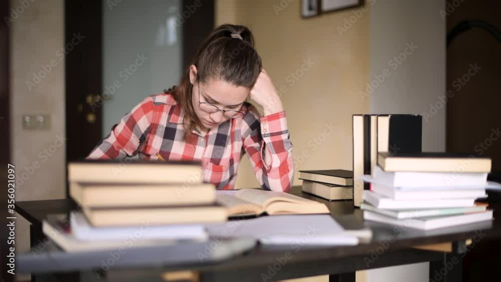 Student girl in correspondence studies studying the material. Distance learning, quarantine, self-isolation Student girl in correspondence studies studying the material. Distance learning, quarantine, self-isolation